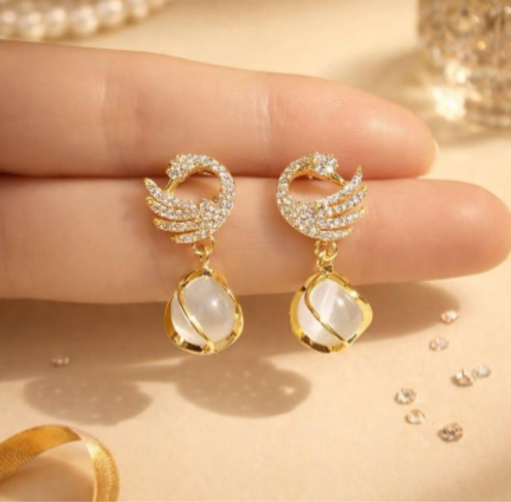 gold-tone crystal swan drop earrings with teardrop accents
