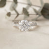 Round Brilliant Moissanite Engagement Ring with Pavé Diamond Band – Classic Four-Prong Solitaire in White, Yellow, or Rose Gold | Finora Jewelry