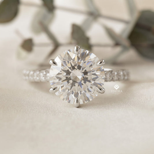 Round Brilliant Moissanite Engagement Ring with Pavé Diamond Band – Classic Four-Prong Solitaire in White, Yellow, or Rose Gold | Finora Jewelry