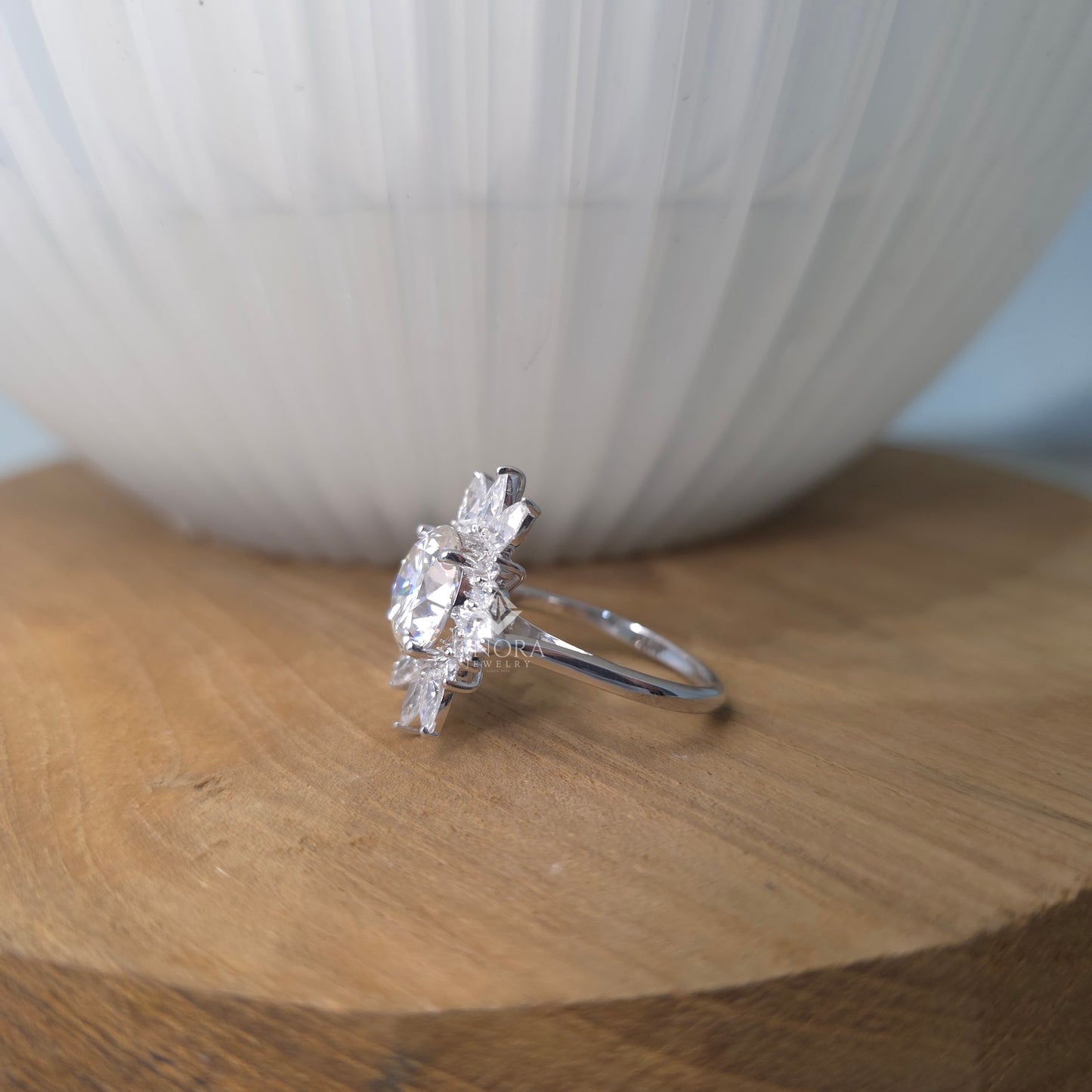 5.41 ct round cut moissanite halo engagement ring with pear & round side stones | finora jewelry