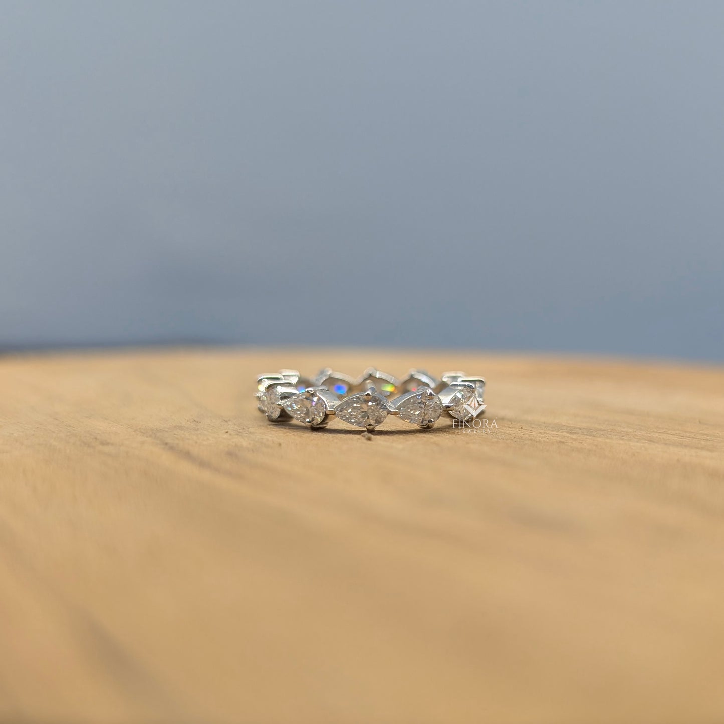pear cut moissanite eternity band by finora