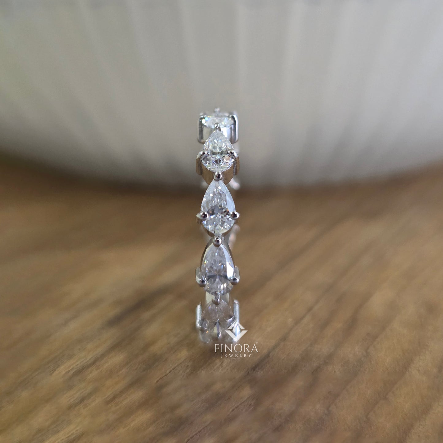 pear cut moissanite eternity band by finora